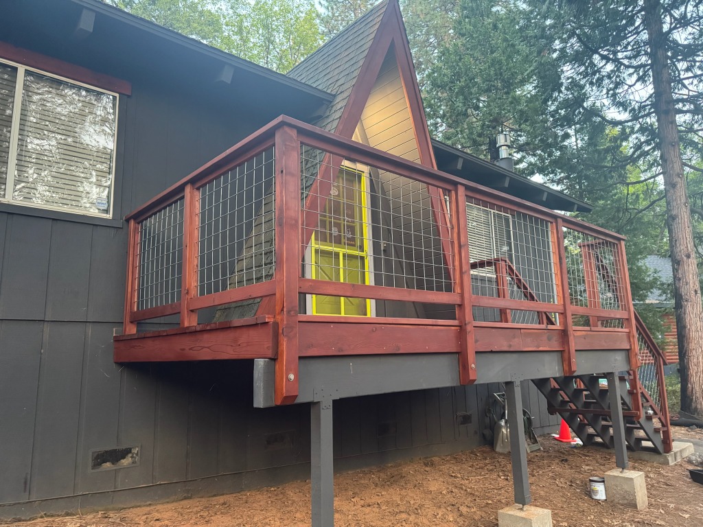 Hog panel mesh railing framed in redwood on a raised deck