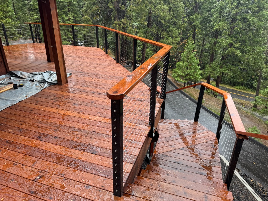 Redwood deck surface and stairs with horizontal wire railing