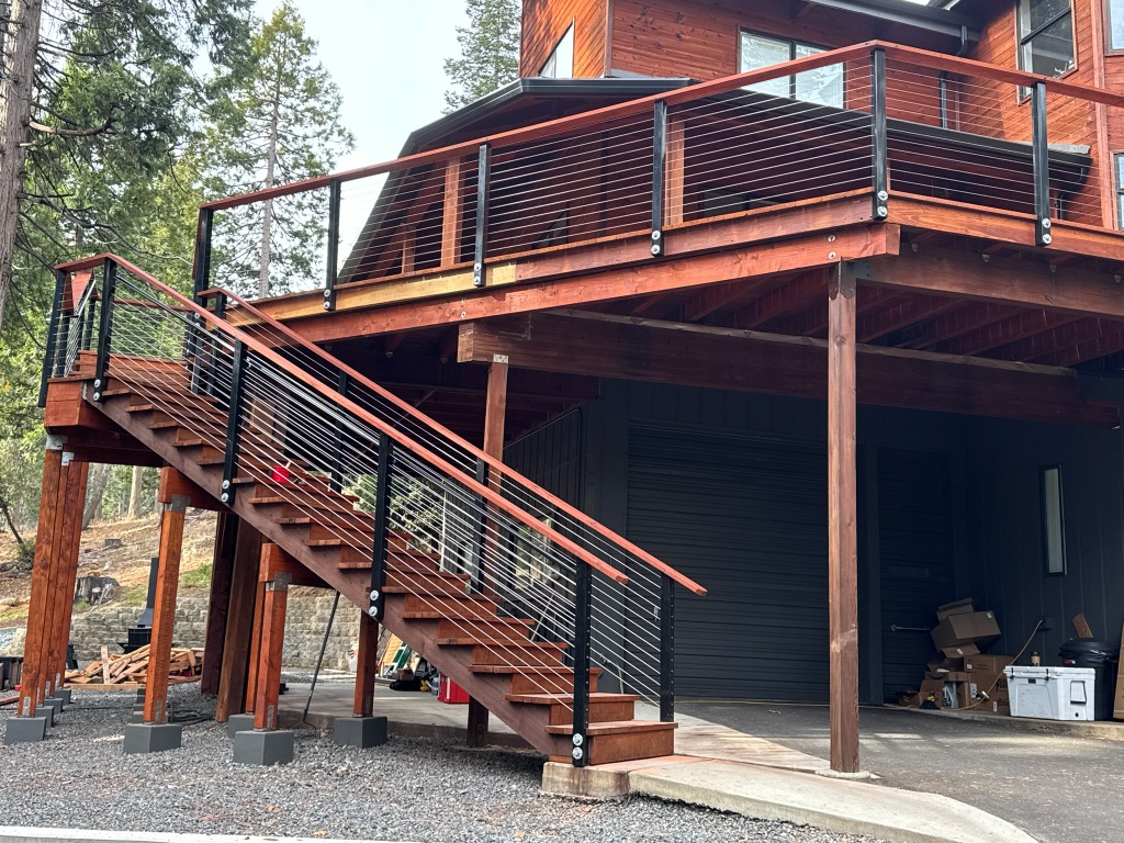 Exterior view of raised redwood deck and stairs with wire railing