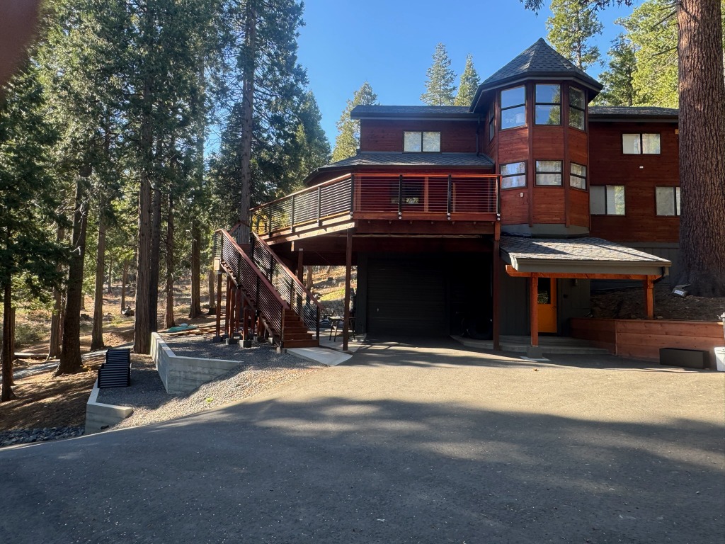 Full view of the house and raised deck among the trees
