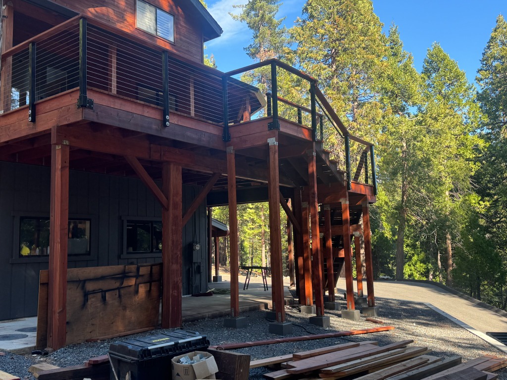 Side view of deck supports, stairs, and wire railing