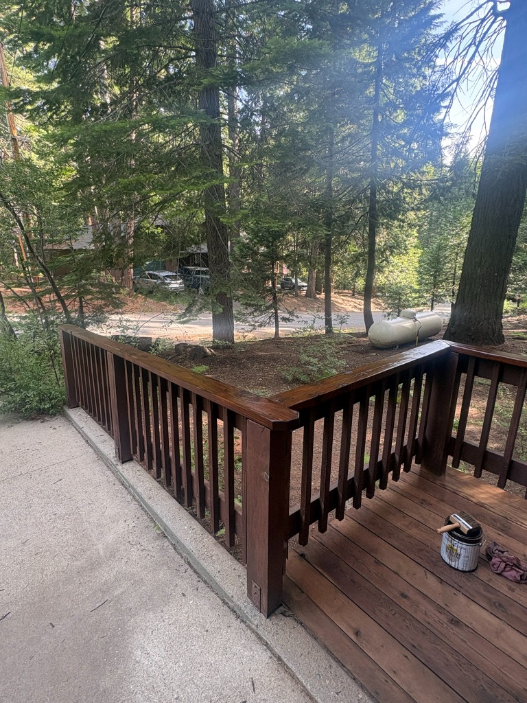 Wood picket railing beside a redwood deck